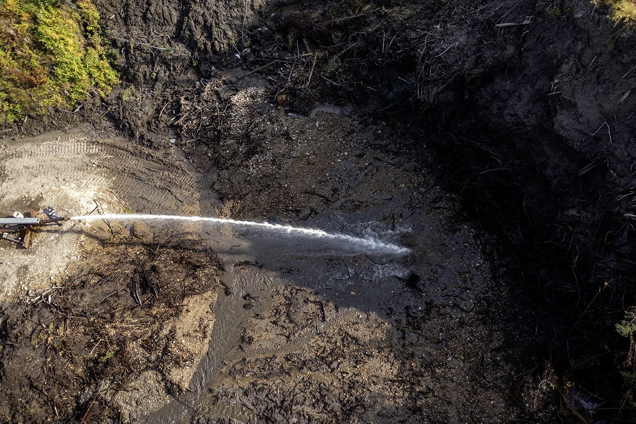 Photo of the dig site at Boneyard Alaska where the giant monitor is melting the permafrost
