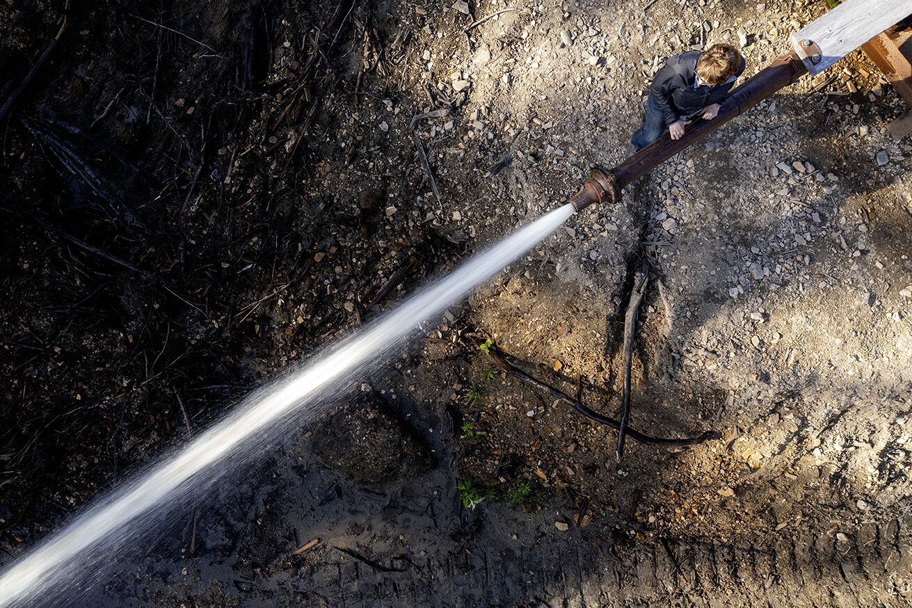Working the giant monitor water cannon at the Boneyard Alaska dig site Alaska