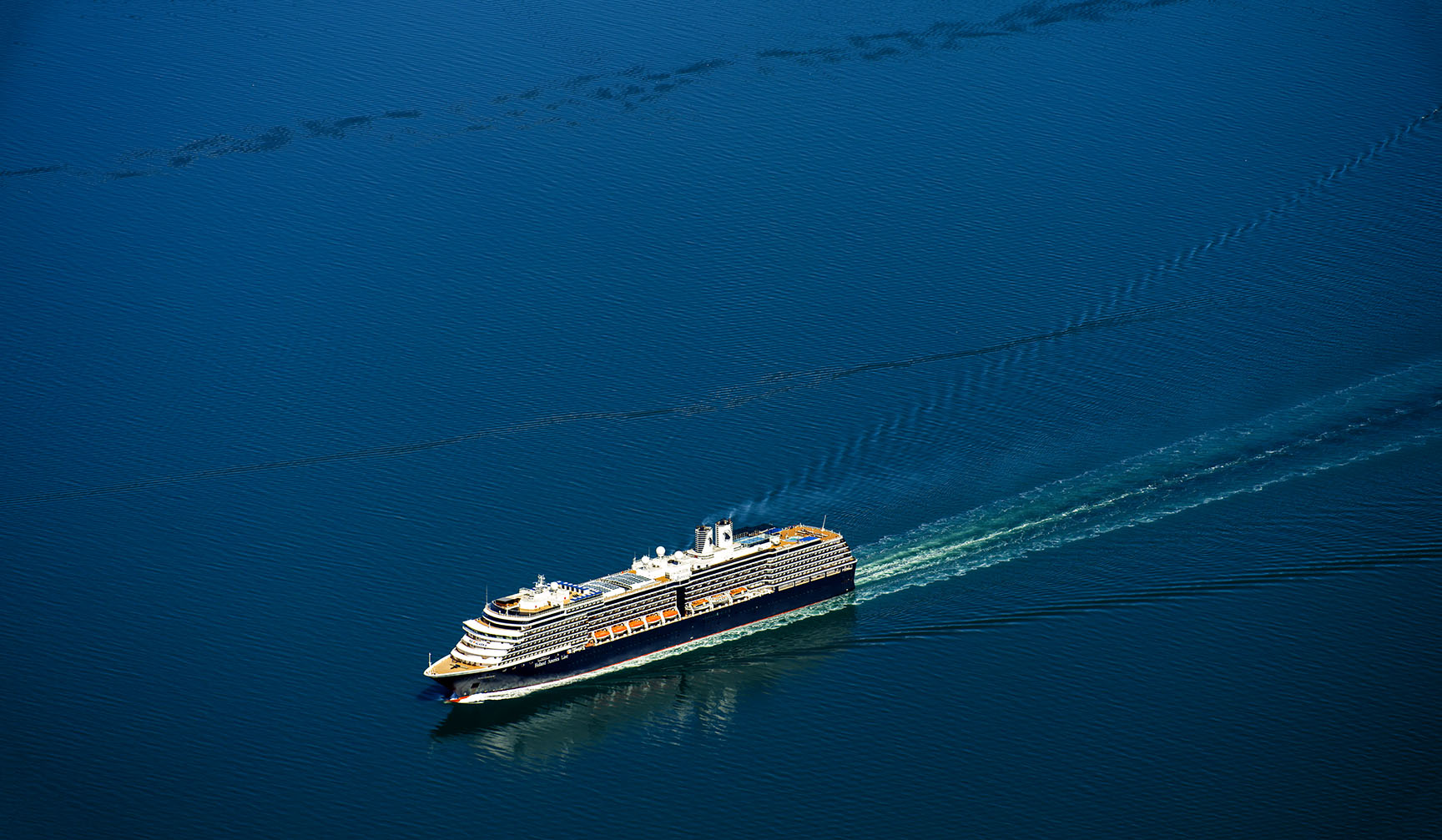 Aerial photo of the cruise ship Westerdam by Holland America Line, sailing in College Fjord in Prince William Sound. Its on its way to Harvard Glacier and Yale Glacier. Tourism in Alaska is dominated by the cruise ship traffic and the inside passage bringing  over one million tourist to Alaska every summer.